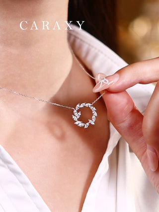 Model hold the lab grown diamond wreath necklace on neck close up.