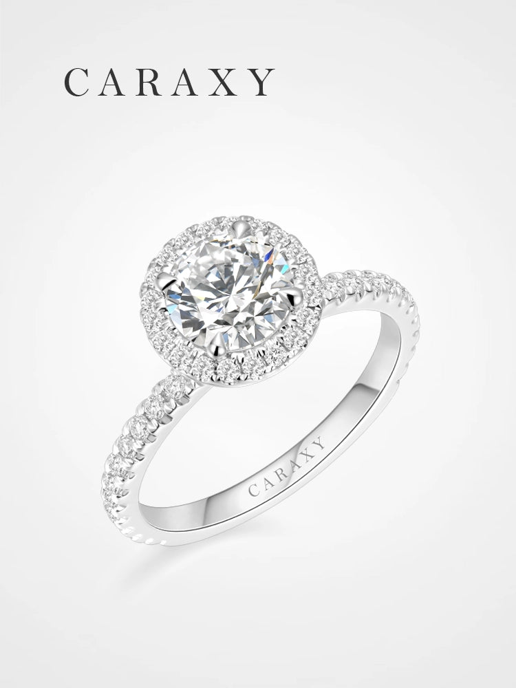 Lab-grown halo engagement ring with a brilliant round center stone and pavé diamond band.