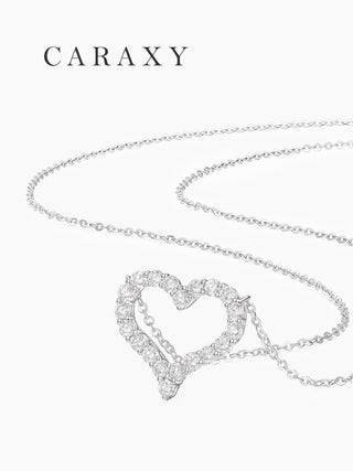 Angled view of a lab grown open heart diamond pendant necklace with round brilliant diamonds.
