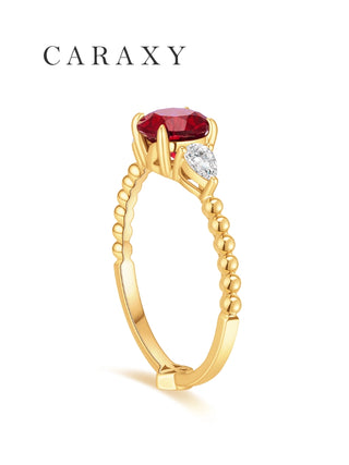 Side view of a round lab grown ruby ring with pear-shaped diamond side stones