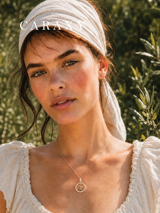 Model wearing the CARAXY Love Forest Tree of Life diamond necklace in 18K yellow gold