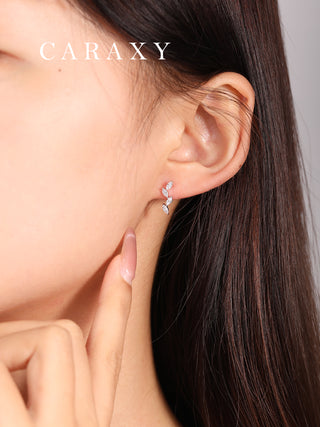 Model wearing marquise diamond drop earrings in a close-up ear view.