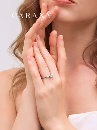 Close-up of a marquise diamond leaf ring on finger to show its delicate floral design.