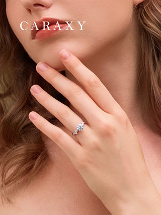 Close-up of a marquise diamond side stone leaf ring on finger to show its delicate floral design.