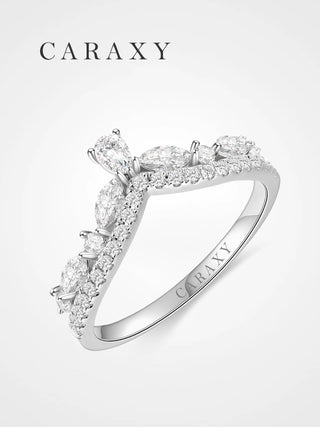 Angled view of an 18K white gold curved wedding band with marquise and pear diamond accents