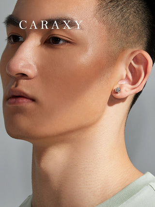 Model wearing men’s diamond stud earrings in a close-up ear view.