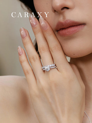 Lifestyle view of a model stack a light tapered band diamond ring with eternity band on hand. 