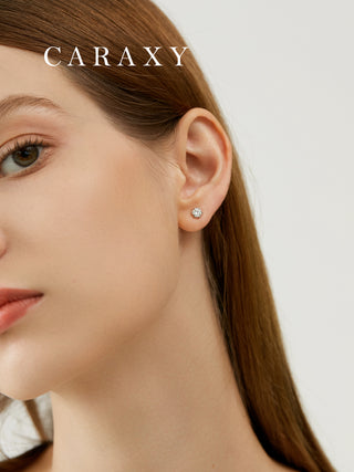 Model wearing minimal diamond stud earrings in a close-up ear view.