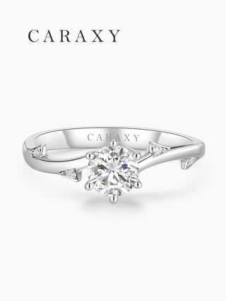 Top view of a minimalist engagement ring with delicate accent stones on the band.