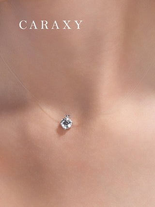 Minimalist floating diamond necklace worn on neckline with clear invisible chain and lab grown diamond pendant.