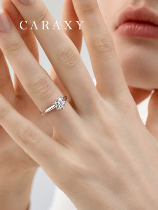 Lifestyle view of a model wearing a minimalist knife edge solitaire diamond ring.
