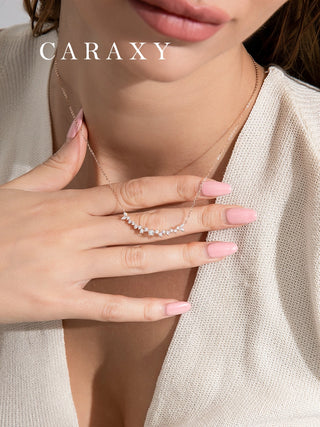 Close-up of a minimalist marquise and round diamond necklace in rose gold, shown on model for a delicate everyday look.