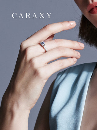 Close-up lifestyle image of the Caraxy butterfly blue diamond engagement ring on a model’s finger, emphasizing its sparkle.