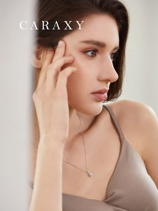 Model wearing a fancy pink lab-grown diamond halo pendant necklace in 18K white gold.