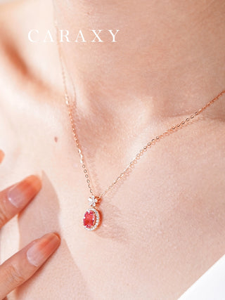 Model wearing a rose gold Padparadscha sapphire halo pendant necklace