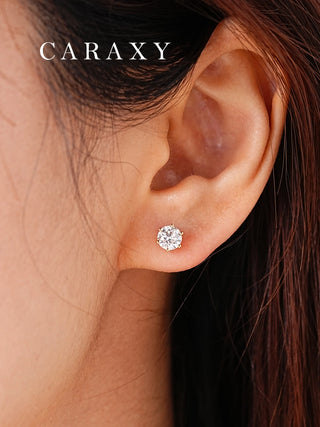 Model wearing round lab-grown diamond stud earrings in 18K yellow gold