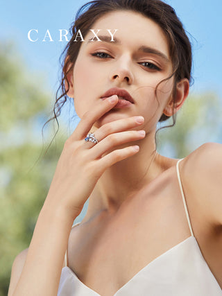model wearing crown inspired blue pear cut diamond ring by CARAXY