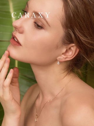 Modern gold diamond drop earrings shown on model with soft natural styling.