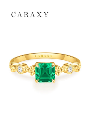 Muzo green emerald birthstone ring with diamond accents.