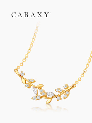 Nature-inspired diamond leaf necklace in 18K yellow gold with a delicate vine design, angled front view.