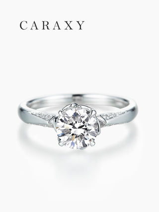 Top view of a nature-inspired engagement ring with tapered pavé diamond accents.