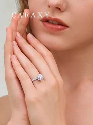 Lifestyle view of a model wearing a nature-inspired floral halo engagement ring.