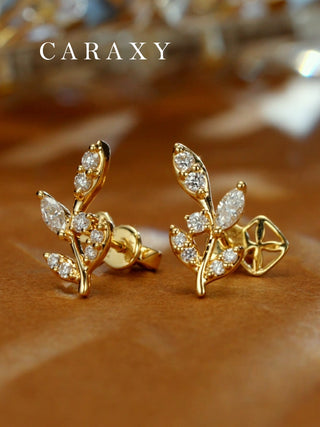 Angled view of nature-inspired leaf earrings featuring marquise and round stones.