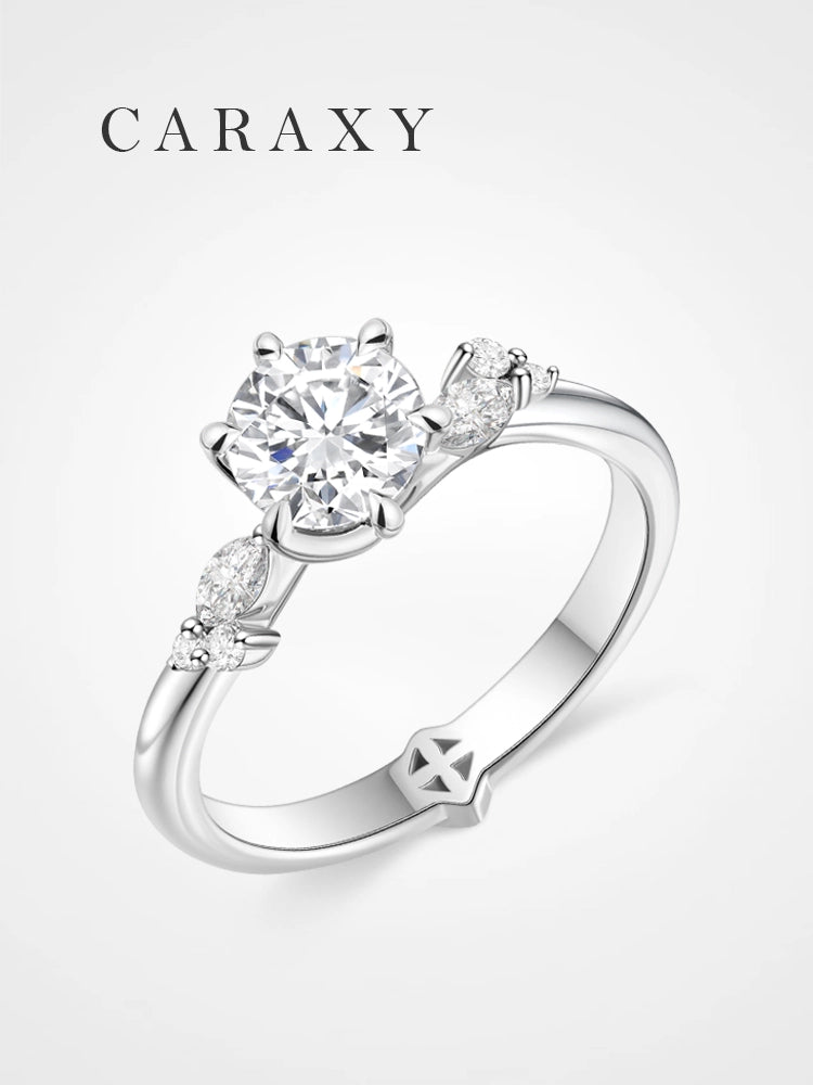 Nature-inspired tulip setting engagement ring with marquise diamond leaf accents.