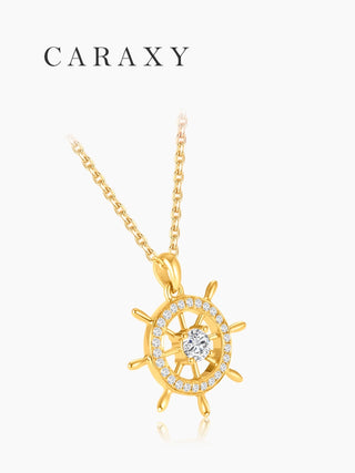Angled view of a nautical diamond pendant necklace in 18K yellow gold with an openwork ship wheel design and round brilliant center stone.