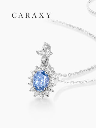 Close-up of a lab-grown oval blue diamond pendant in 18K white gold with a round diamond halo.