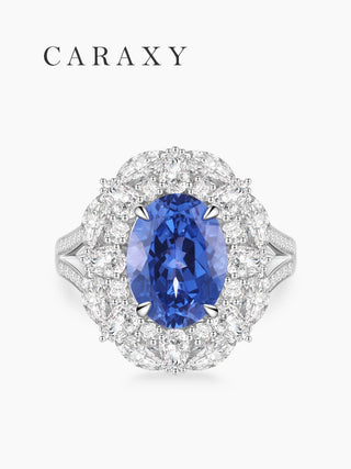 Oval blue sapphire ring with leaf-inspired diamond halo.
