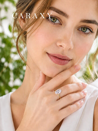 Model wearing a CARAXY oval cut engagement ring in yellow gold