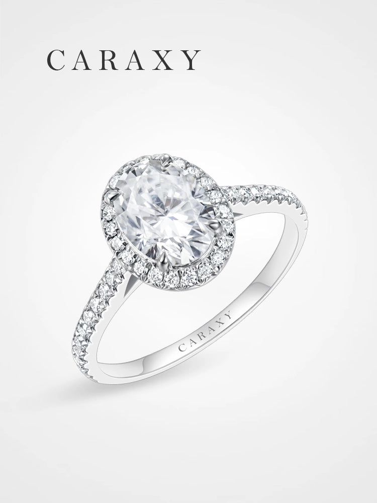 Oval cut halo engagement ring with a brilliant lab-grown diamond and pavé band.