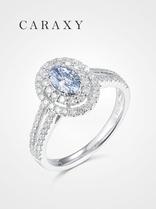 A luxurious oval blue diamond engagement ring with a double halo and split shank.
