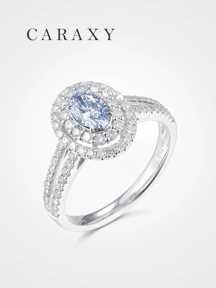 A luxurious oval blue diamond engagement ring with a double halo and split shank.