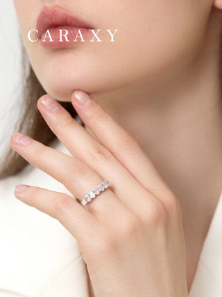 Woman wearing an oval lab grown 7 stone diamond band in 18K white gold