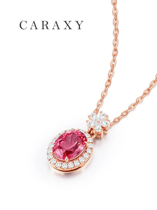 Angled view of an oval Padparadscha sapphire pendant with a round diamond halo