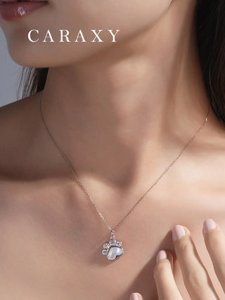 Paw inspired mother of pearl diamond necklace worn on model.
