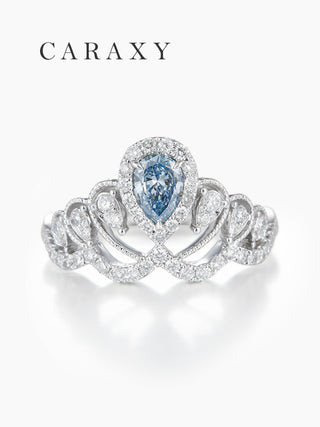 Top view of a stunning pear-shaped fancy blue diamond ring with a wide pavé band.