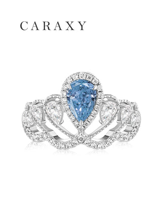 Top view of a stunning pear-shaped fancy blue diamond ring with a wide pavé band.