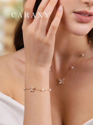 Butterfly pearl bracelet styled with a coordinating necklace in 18K yellow gold