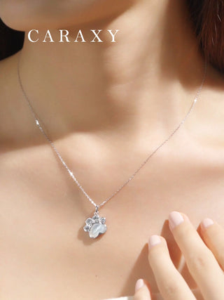 Mother of pearl paw inspired diamond necklace for pet lovers shown on mode.