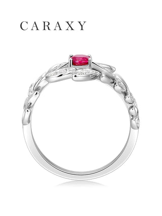 Side view of a lab created Pigeon Blood Ruby ring showing the raised oval center stone and leaf bypass design.