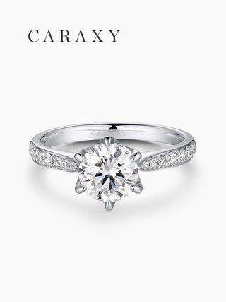 Top view of a classic diamond solitaire ring with a micro pavé platinum band.