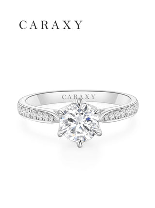 Top view of a classic diamond solitaire ring with a micro pavé platinum band.