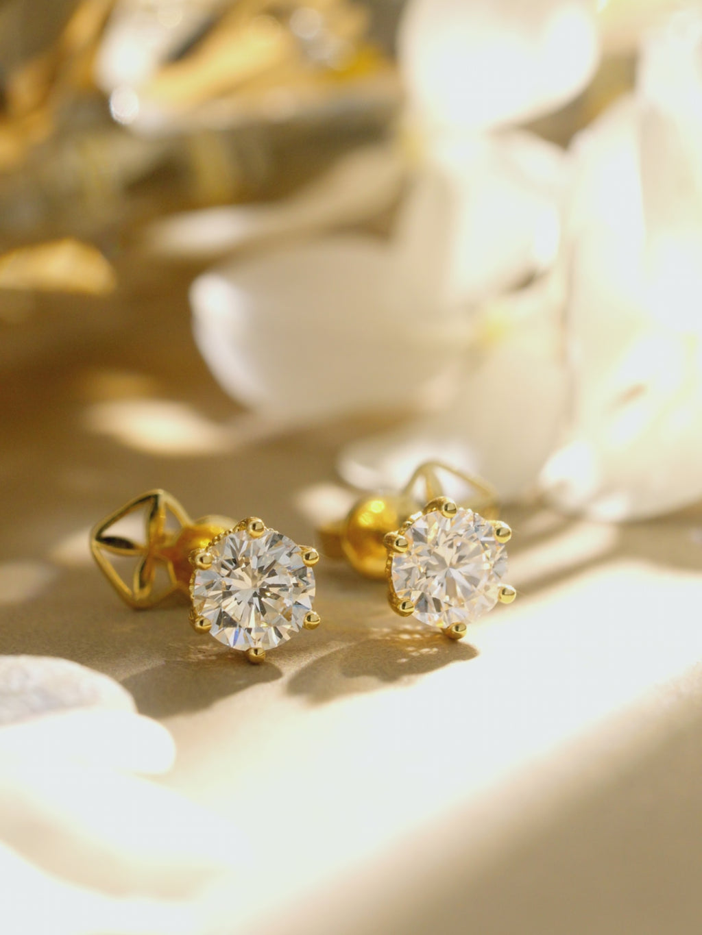 Multi-angle view of round lab-grown diamond stud earrings in 18K yellow gold.