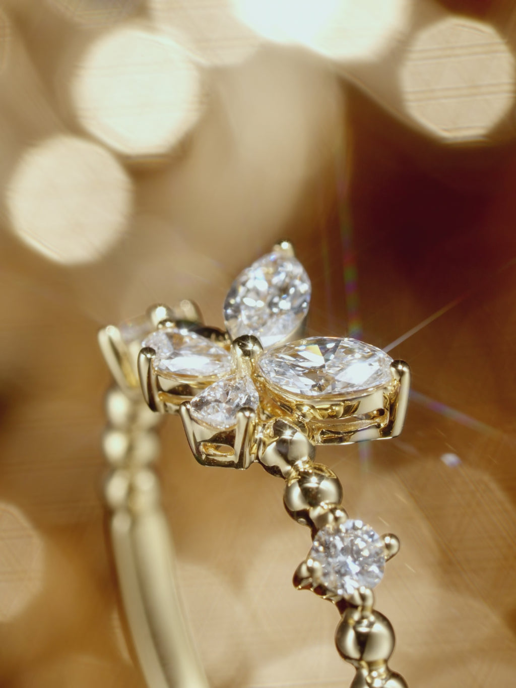 Multi-angle view of an 18K yellow gold butterfly lab-grown diamond ring.