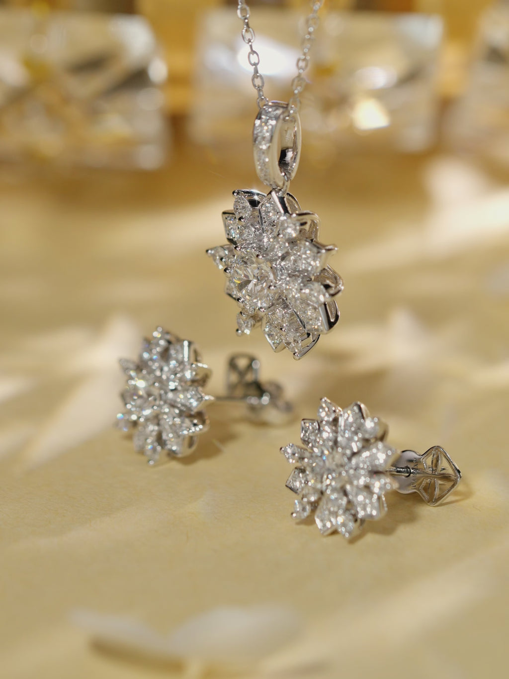 Video shows the floral halo diamond studs and matched pendant necklace.