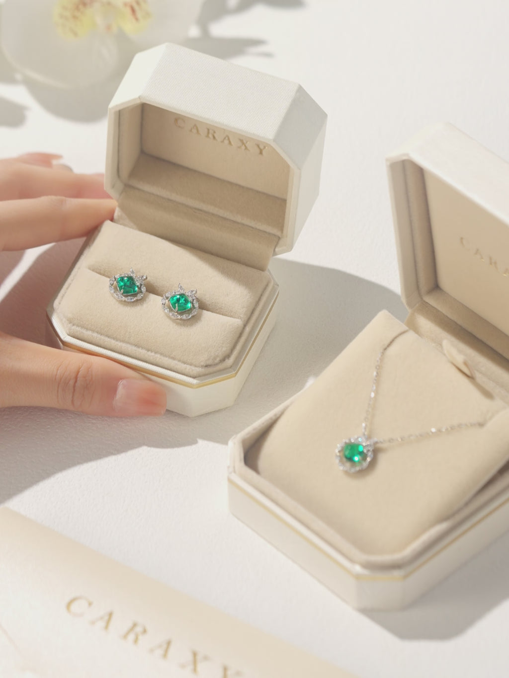 Sugarloaf emerald and lab grown diamond butterfly necklace in 18K white gold shown from multiple angles and worn on the neckline