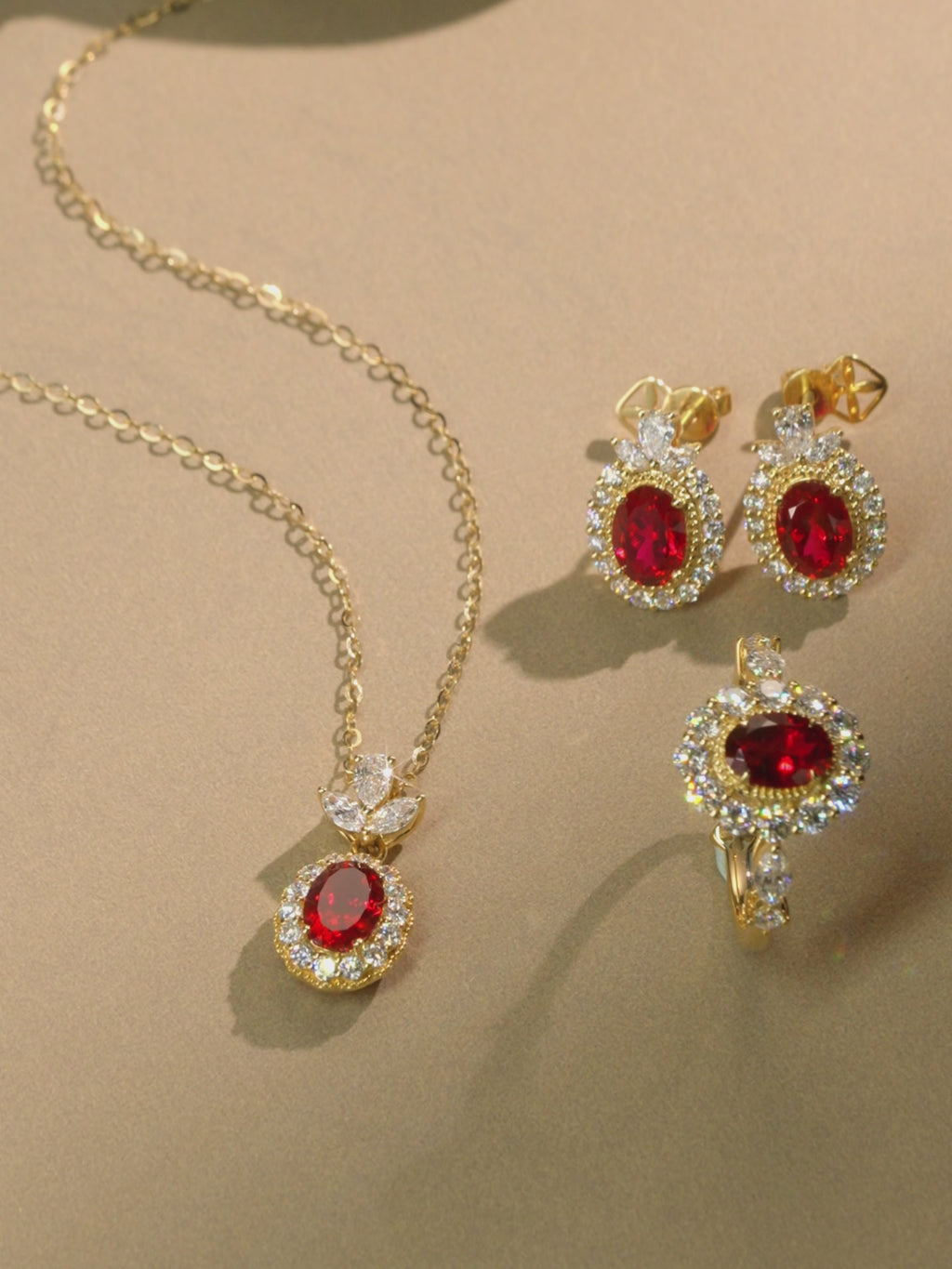 Oval lab grown ruby and diamond halo jewelry shown from multiple angles, highlighting the floral diamond setting